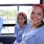 Two IMR volunteers traveling to clinic on a bus in Zambia | Short-term medical mission missions for undergraduate students from IMR offer the opportunity to participate in patient care in a clinic setting