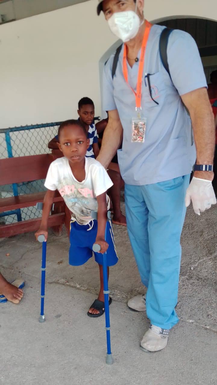 boy with amputated leg using crutches