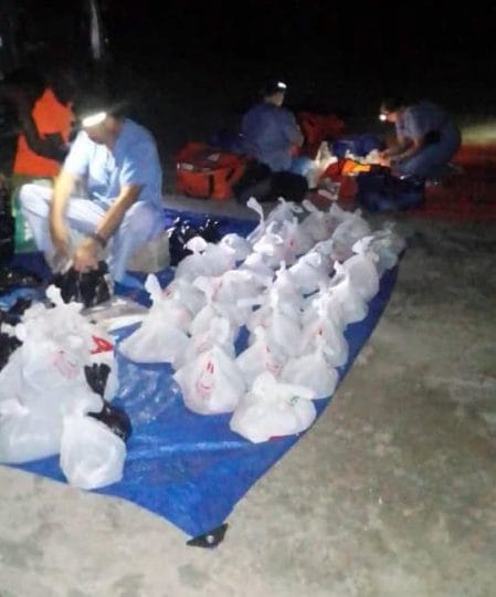 Volunteers packaging food in Haiti