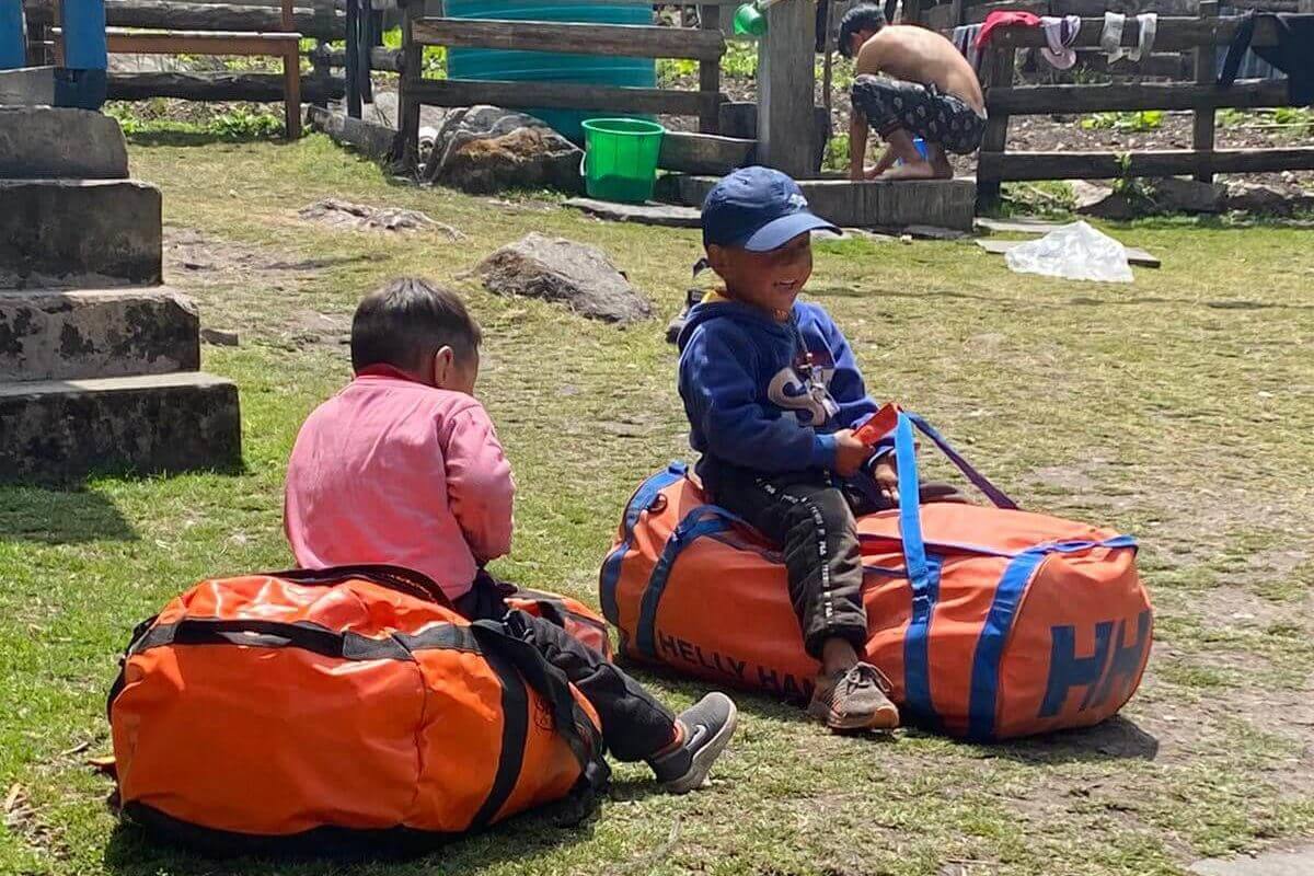 Nepali boys play on IMR supply bags