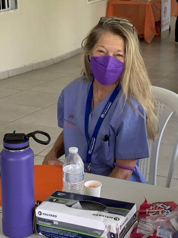 volunteer sitting at table with medical supplies