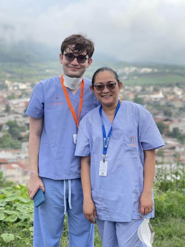 volunteers smiling in scrubs