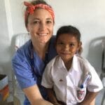 IMR volunteer and girl patient in clinic, Indonesia