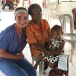 Volunteer with mom and baby at clinic in Indonesia