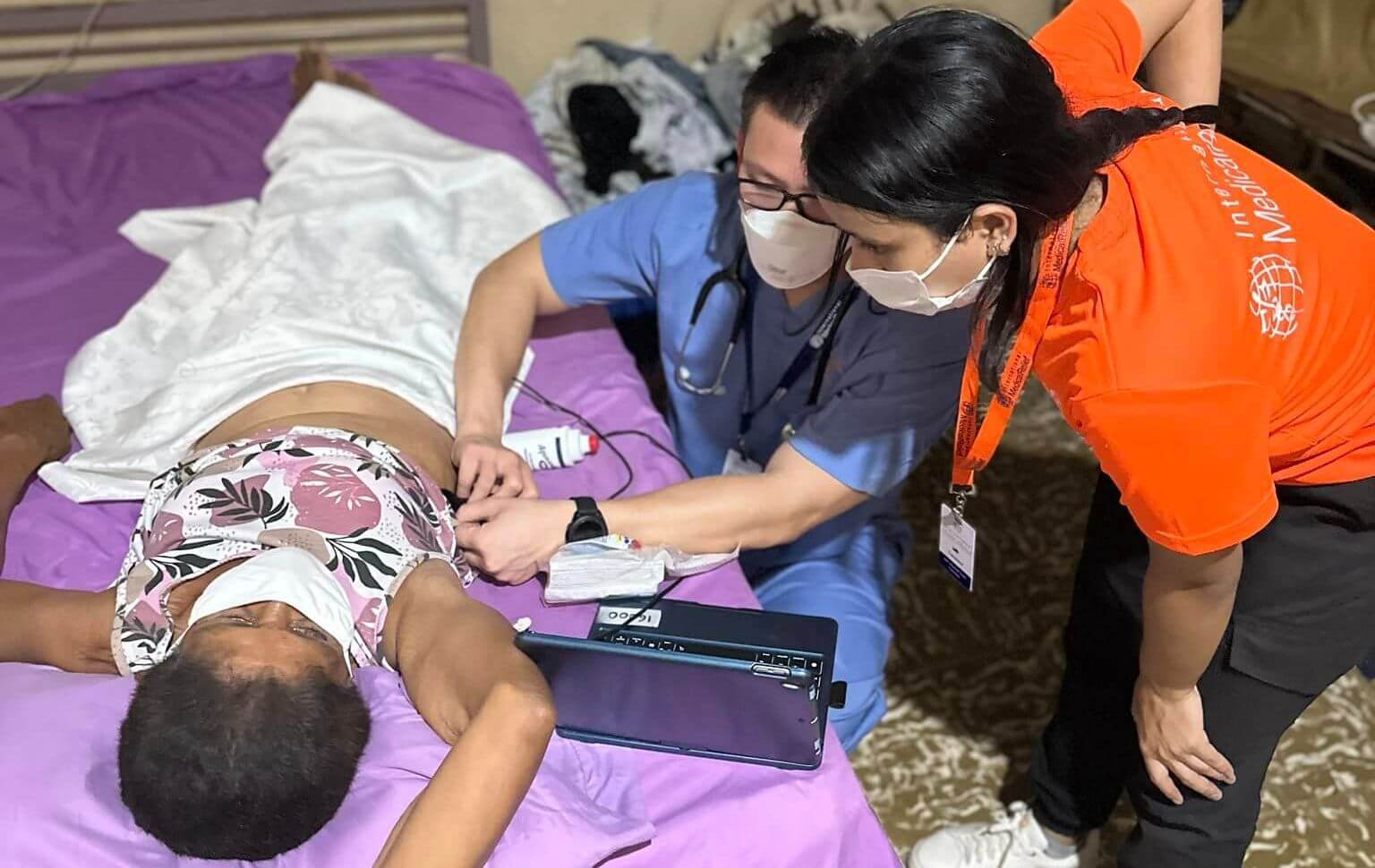 IMR provider using a butterfly ultrasound on a patient