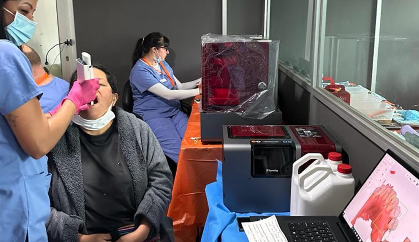 IMR dental volunteer maps a patient's teeth for a 3D printed dental bridge