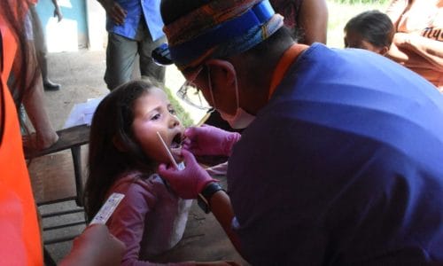 Girl being examined by an IMR dental volunteer: Dental Volunteer Opportunities with IMR